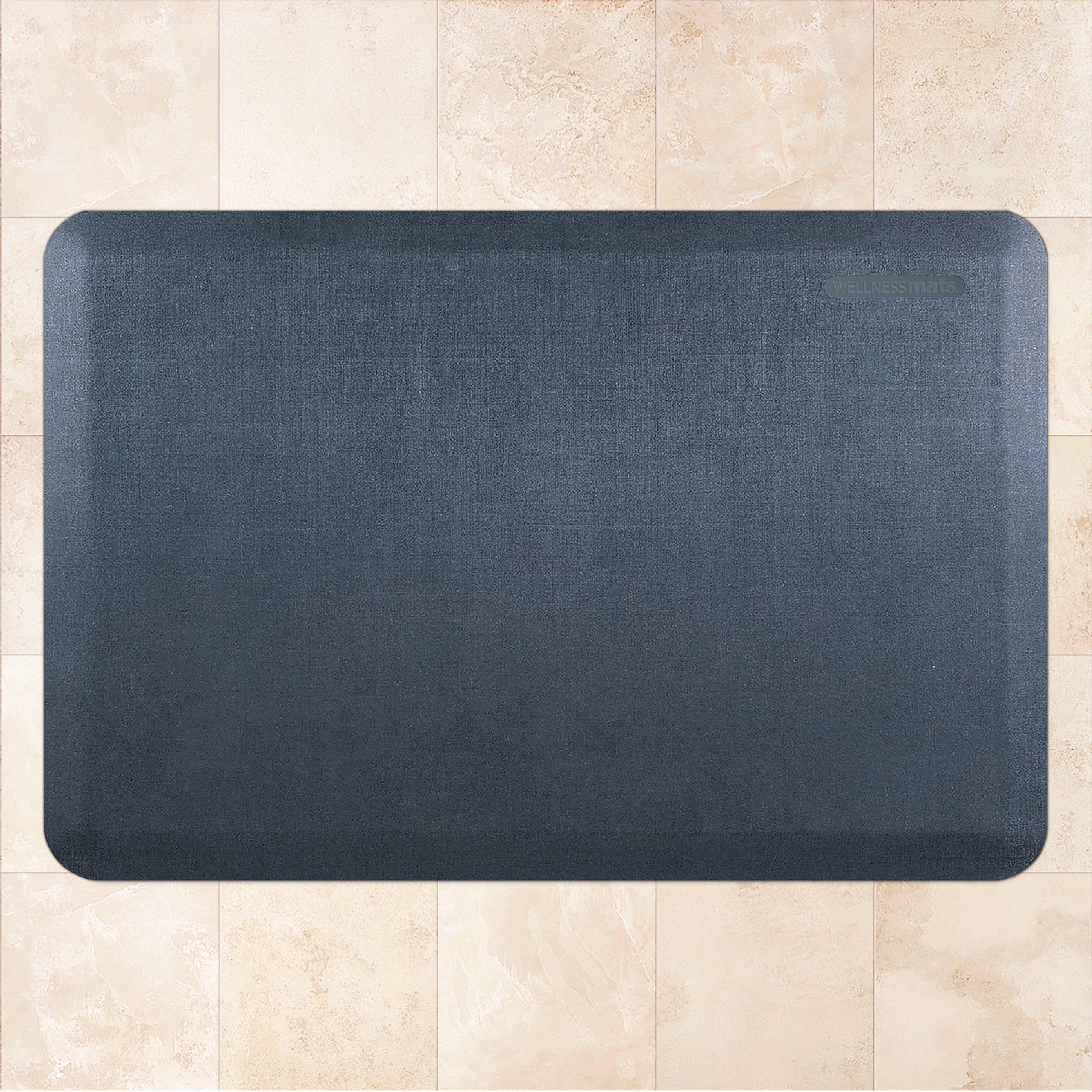 A 3'x2' Linen Lagoon WellnessMat on a tile floor.