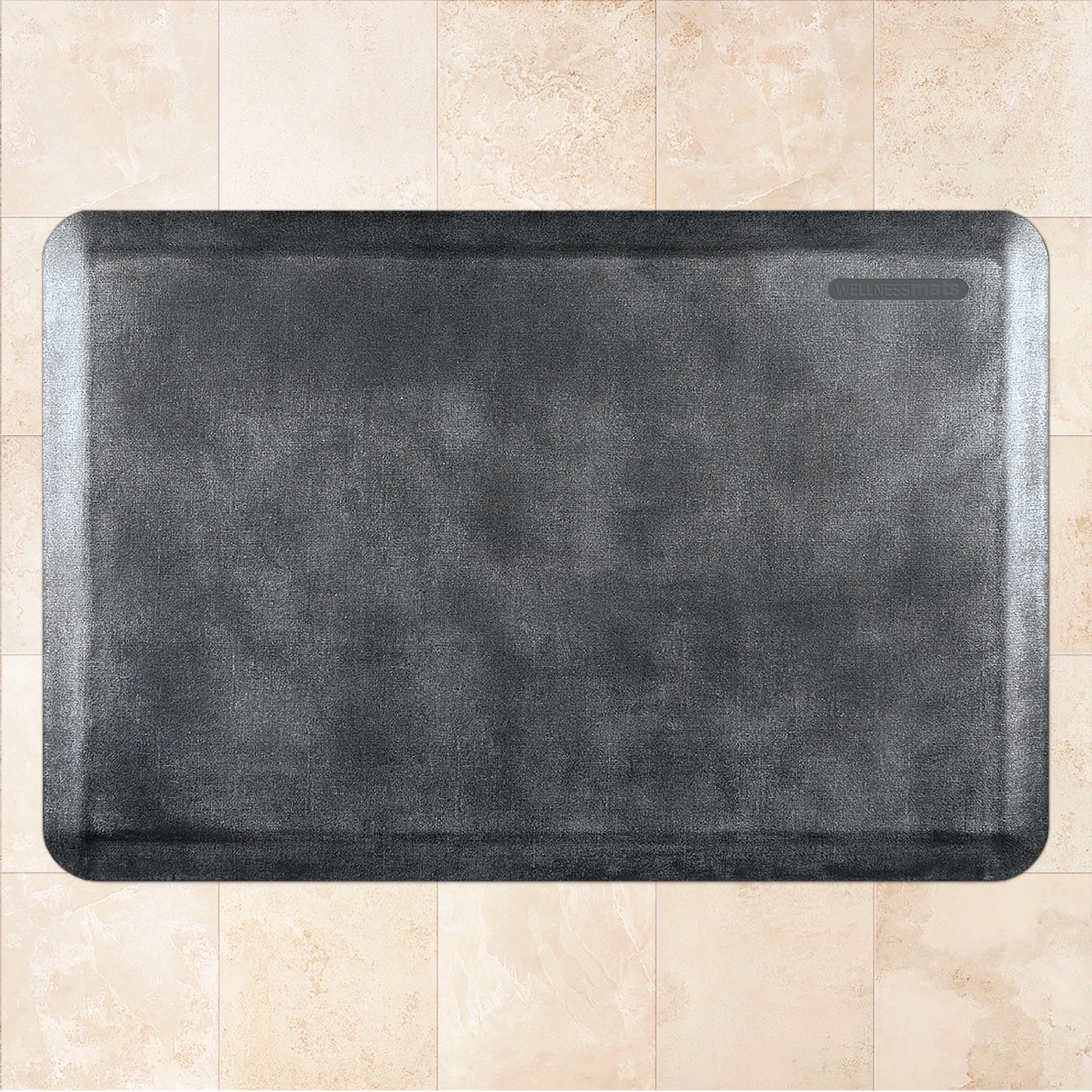 A 3'x2' Linen Onyx WellnessMat on a tile floor
