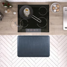 A 3'x2' Linen Lagoon WellnessMat in front of a kitchen stove.