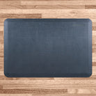 A 3'x2' Linen Lagoon WellnessMat on a  light wood floor.