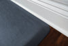 A up-close shot of 3'x2' Linen Lagoon WellnessMat on a wood floor.