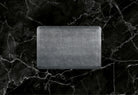 A 3'x2' Linen Slate WellnessMat on black marble. 