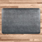A 3'x2' Linen Slate WellnessMat on a light wood floor. 