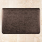 A 3'x2' Antique Dark WellnessMat on a tile floor.