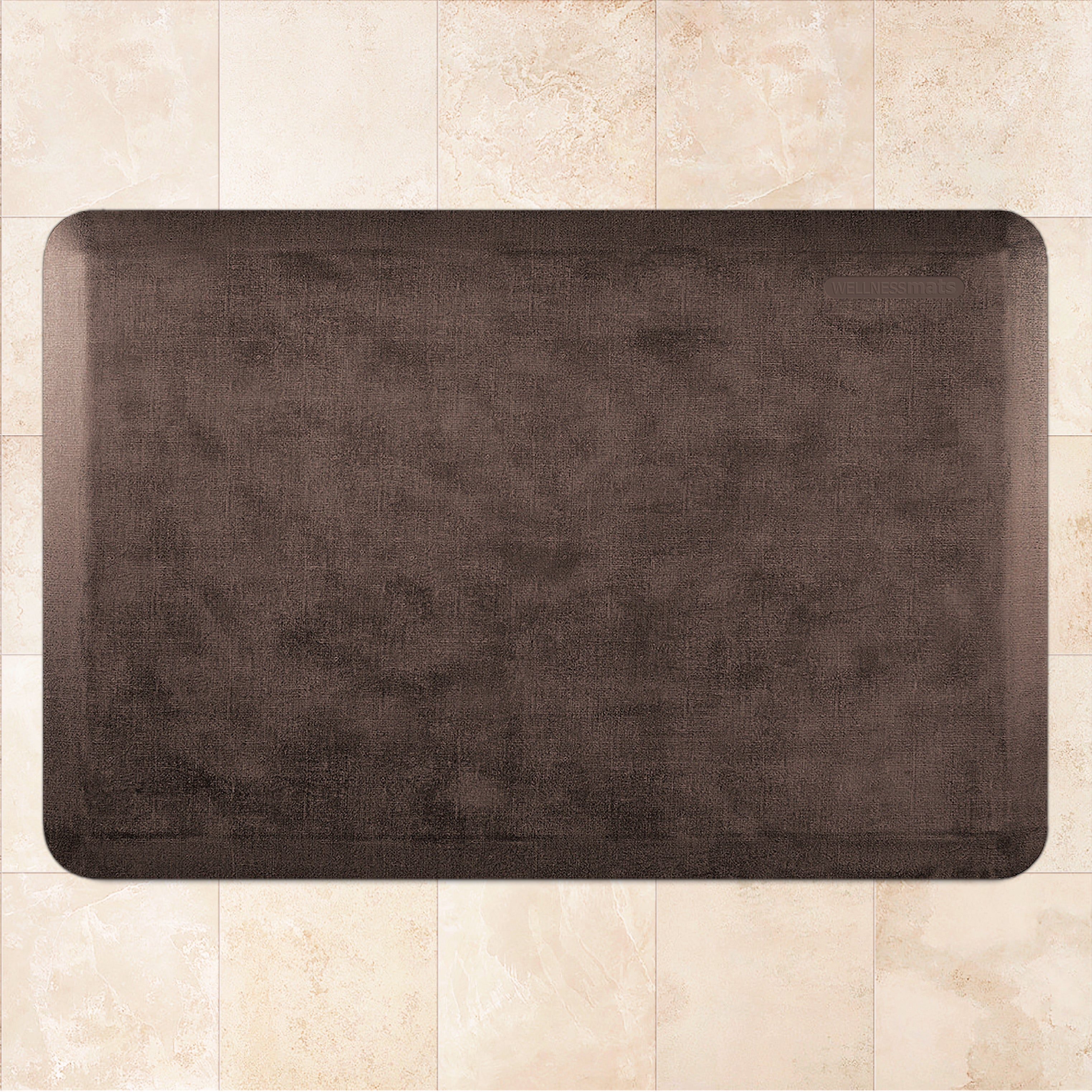 A 3'x2' Antique Dark WellnessMat on a tile floor.