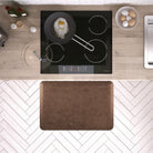 A 3'x2' Antique Light WellnessMat in front of a kitchen stove.