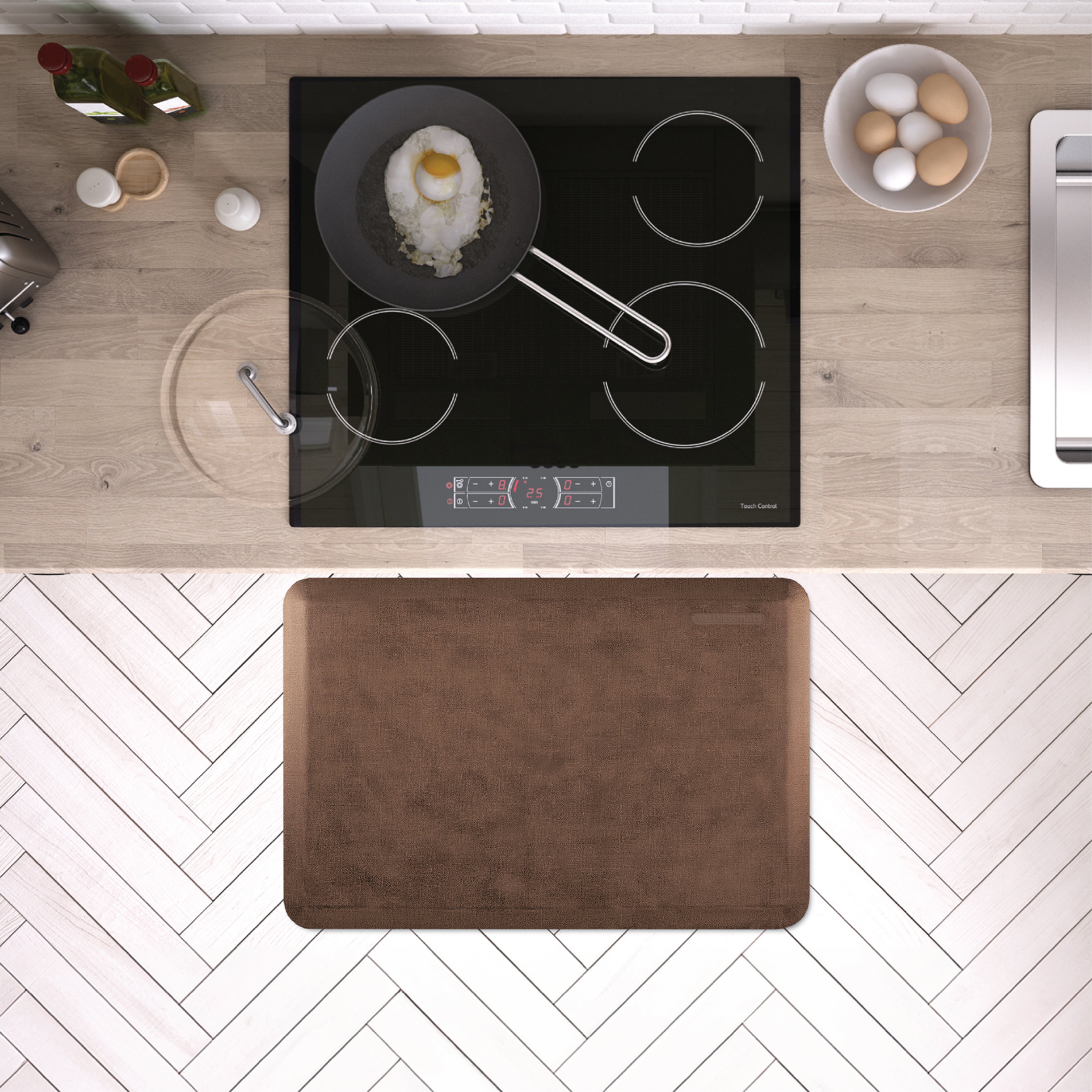 A 3'x2' Antique Light WellnessMat in front of a kitchen stove.